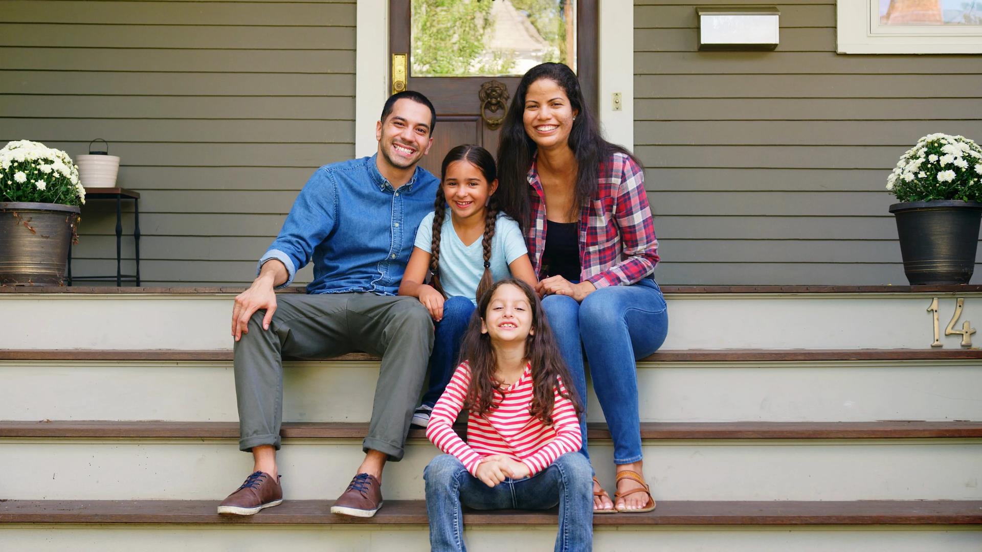 Family In Front of House